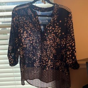 Nice blouse that’s blue with small pale pink and violet flowers touch of white.